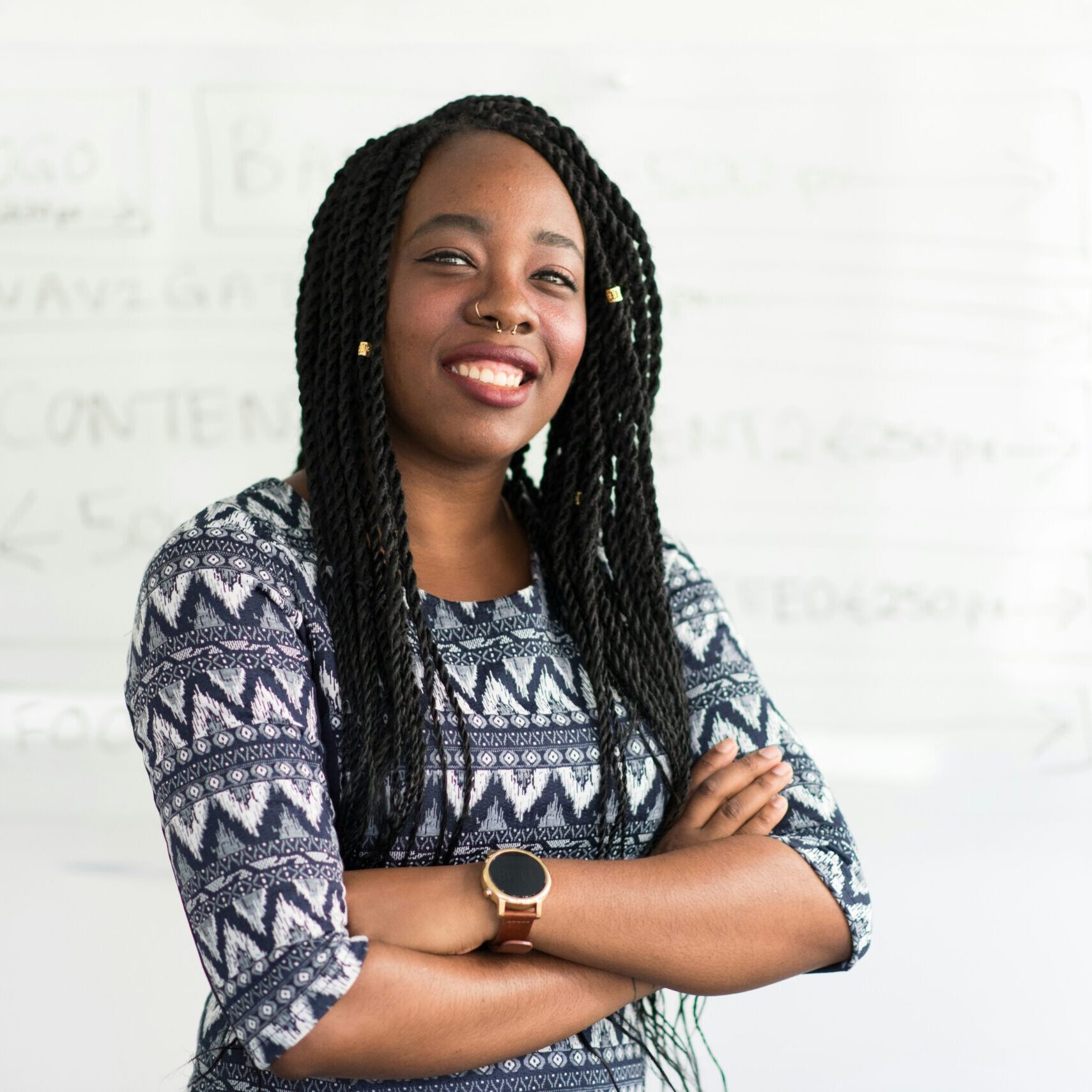 African Woman in Business Attire Standing Against White Background Confident African woman dressed in business attire standing in front of a plain white background.